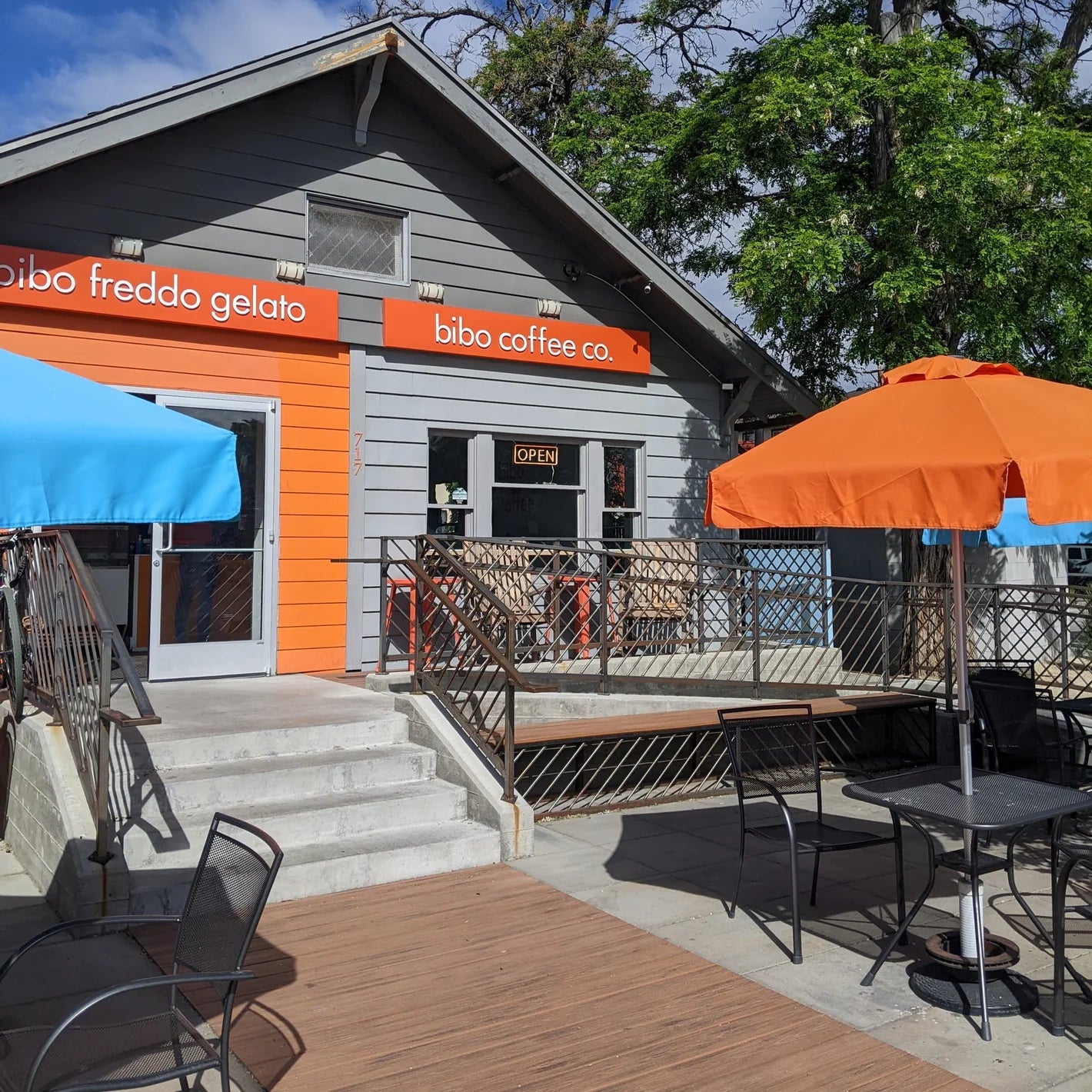 Building with Bibo Coffee Co. sign and outdoor seating area on a sunny day