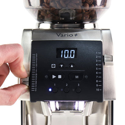 Coffee grinder with digital display and control panel, showing the brand 'Vario+'.