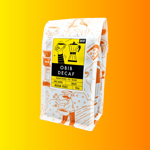 Side view of a 12oz Bibo Coffee Co. bag showing a bright yellow label for 'OBIB Decaf' medium roast coffee from Brazil, processed using the Swiss Water method, with tasting notes of graham cracker, fig, and walnut.